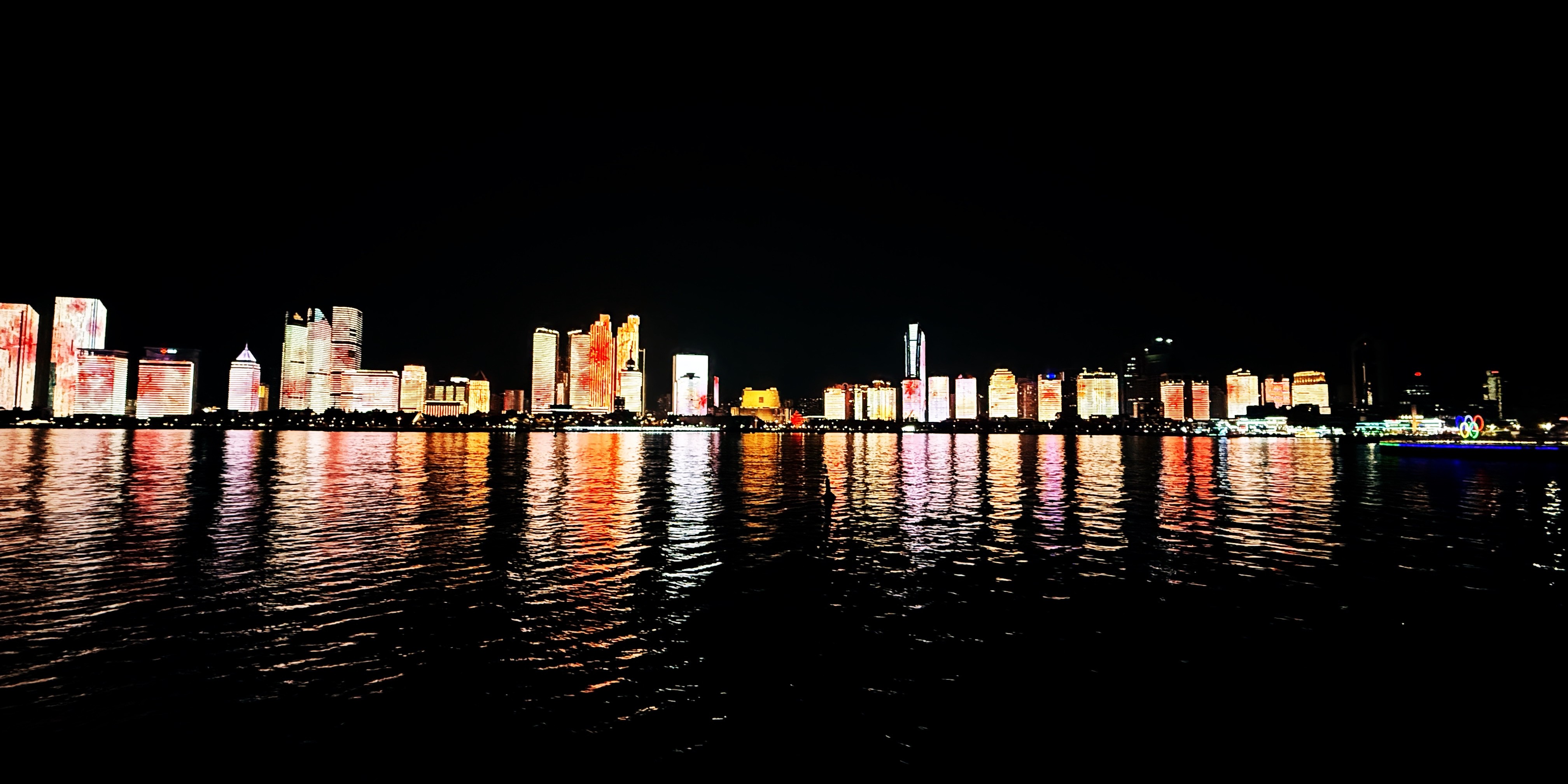 A view from the harbour of modern skyscrapers trace along the coastline in Qingdao, China.