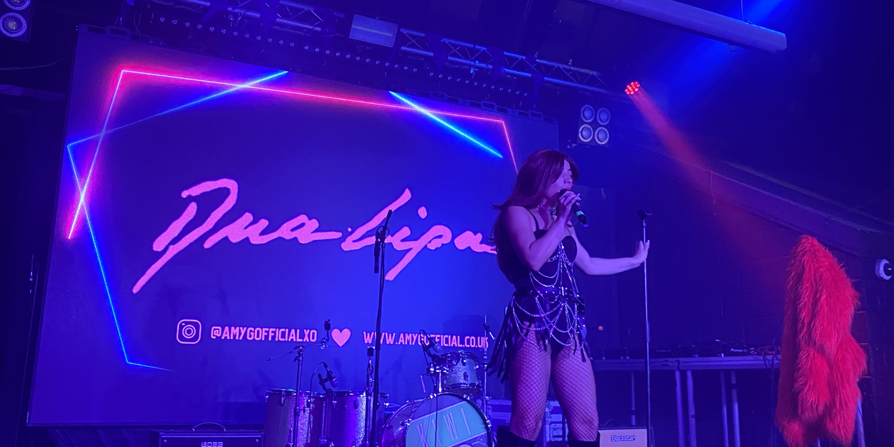 A nightout in Sugar House with a peron on the stage singing.