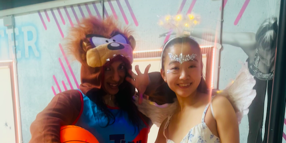 Two people smiling and posing for a picture at the BodyJam fitness class. 