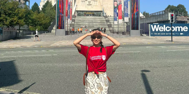 A person standing in front of Liverpool Metropolitan Cathedral. 