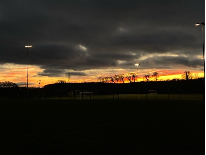 A sunset view above a woodland trail at Lancaster University.