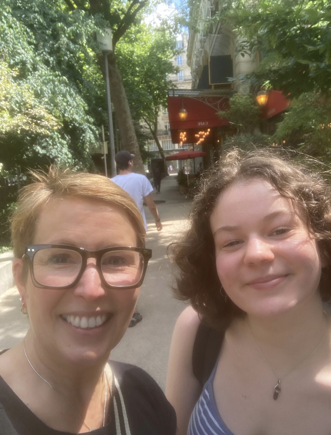 Martha and her mum smiling for a selfie on the street under a nice weather.