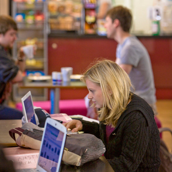 A student working at a laptop in County Diner