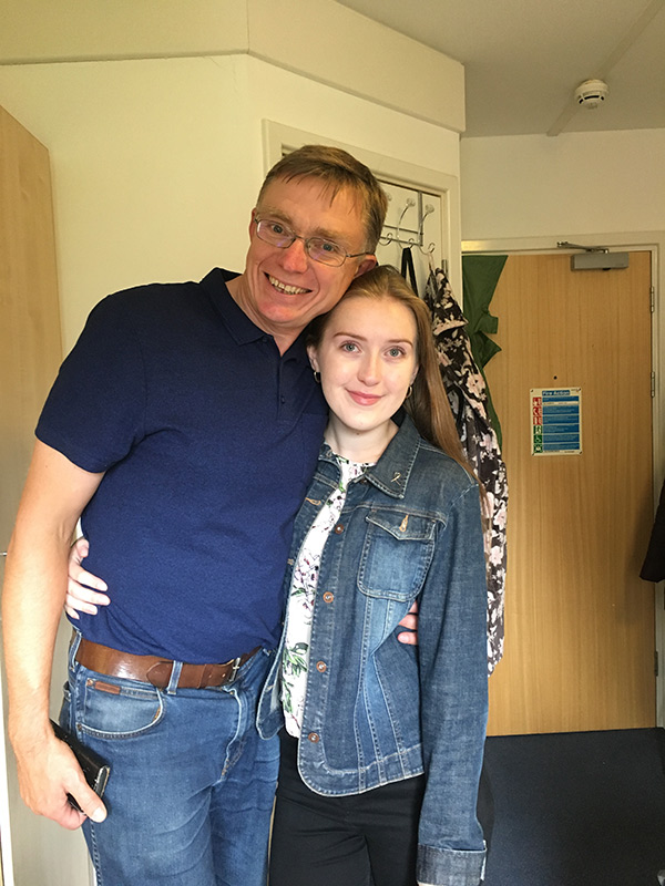 A female student in a study bedroom with her dad