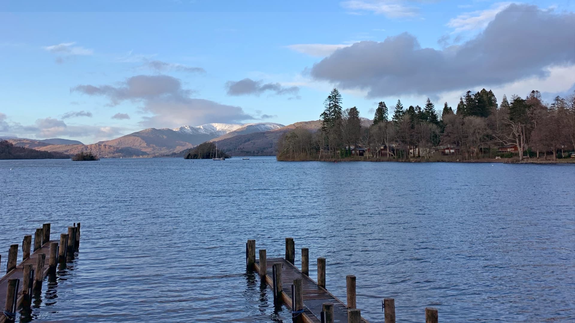 A view over Windermere in winter with snow capped mountains