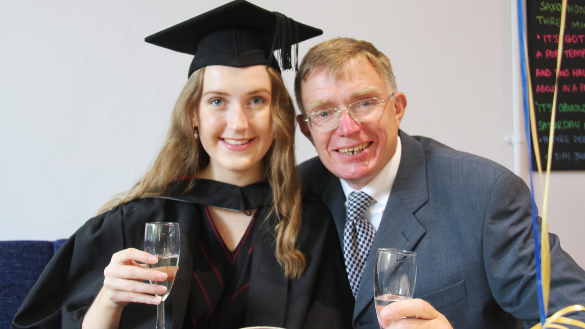 Catherine and her father celebrate with prosecco