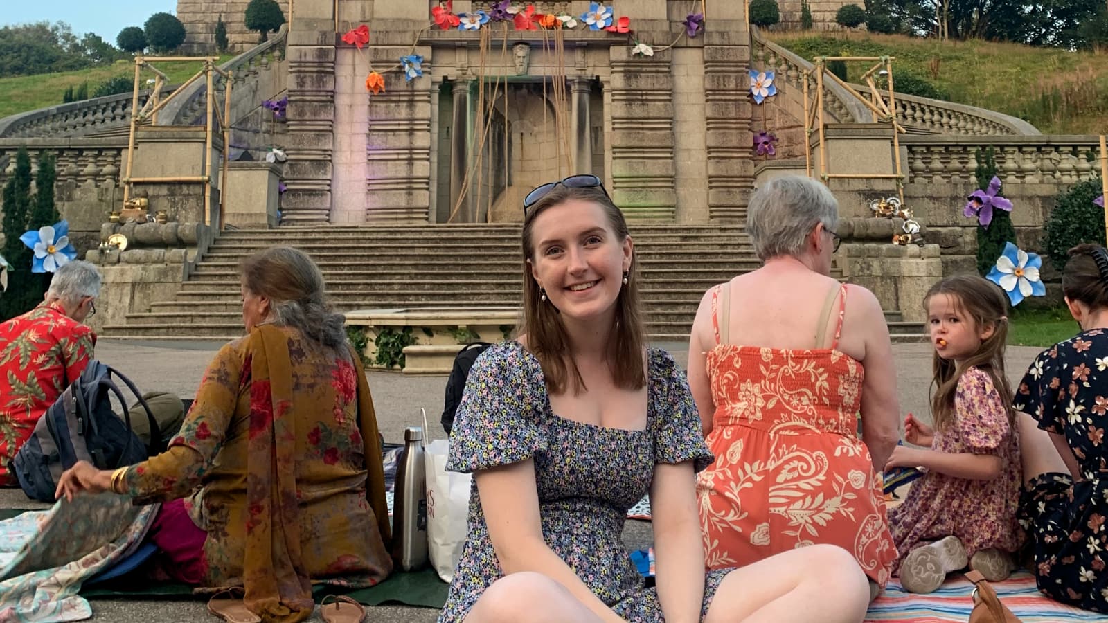 Catherine sits in front of the Ashton Memorial