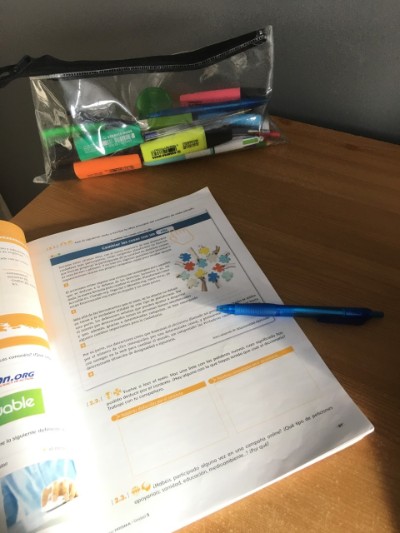 Textbook with pen and highlighters