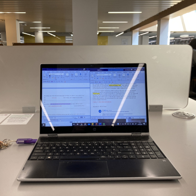 Image of laptop on a desk in the library