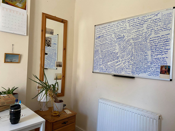 A desk and a whiteboard in a student room