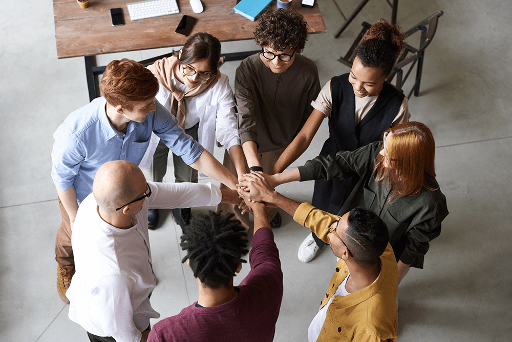 Group of professionals putting hands together in a circle