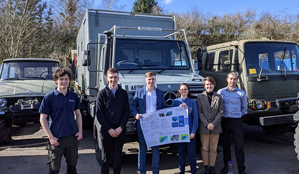 Staff from Atkinson VOS and LU in front of trucks celebrating the success of a KTP partnership