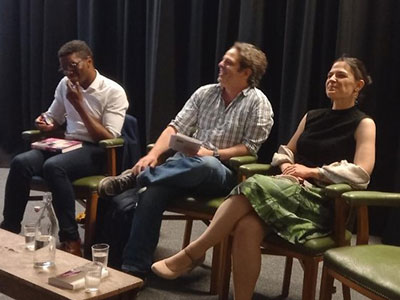 Three ELCW authors sitting in a Theatre