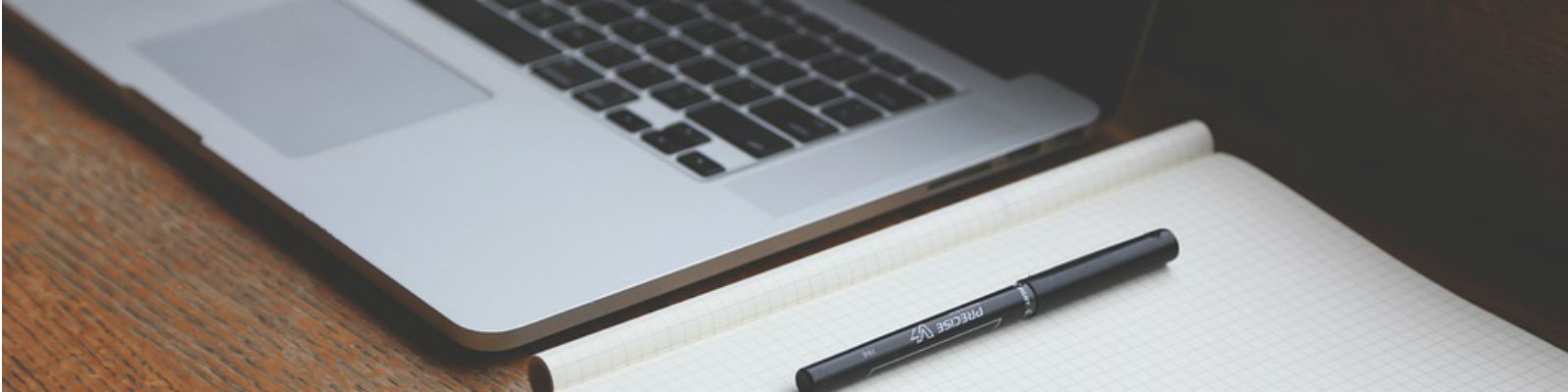 Photo of laptop and pad on table