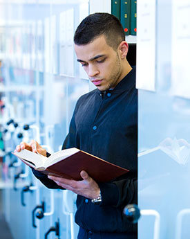 Student in the Library reading a book