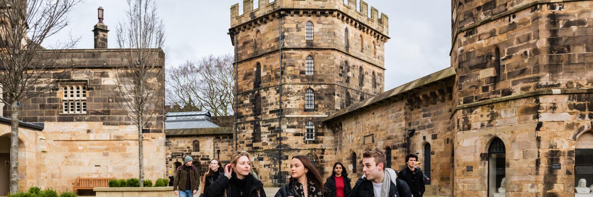 Group of people in Lancaster Castle courtyard