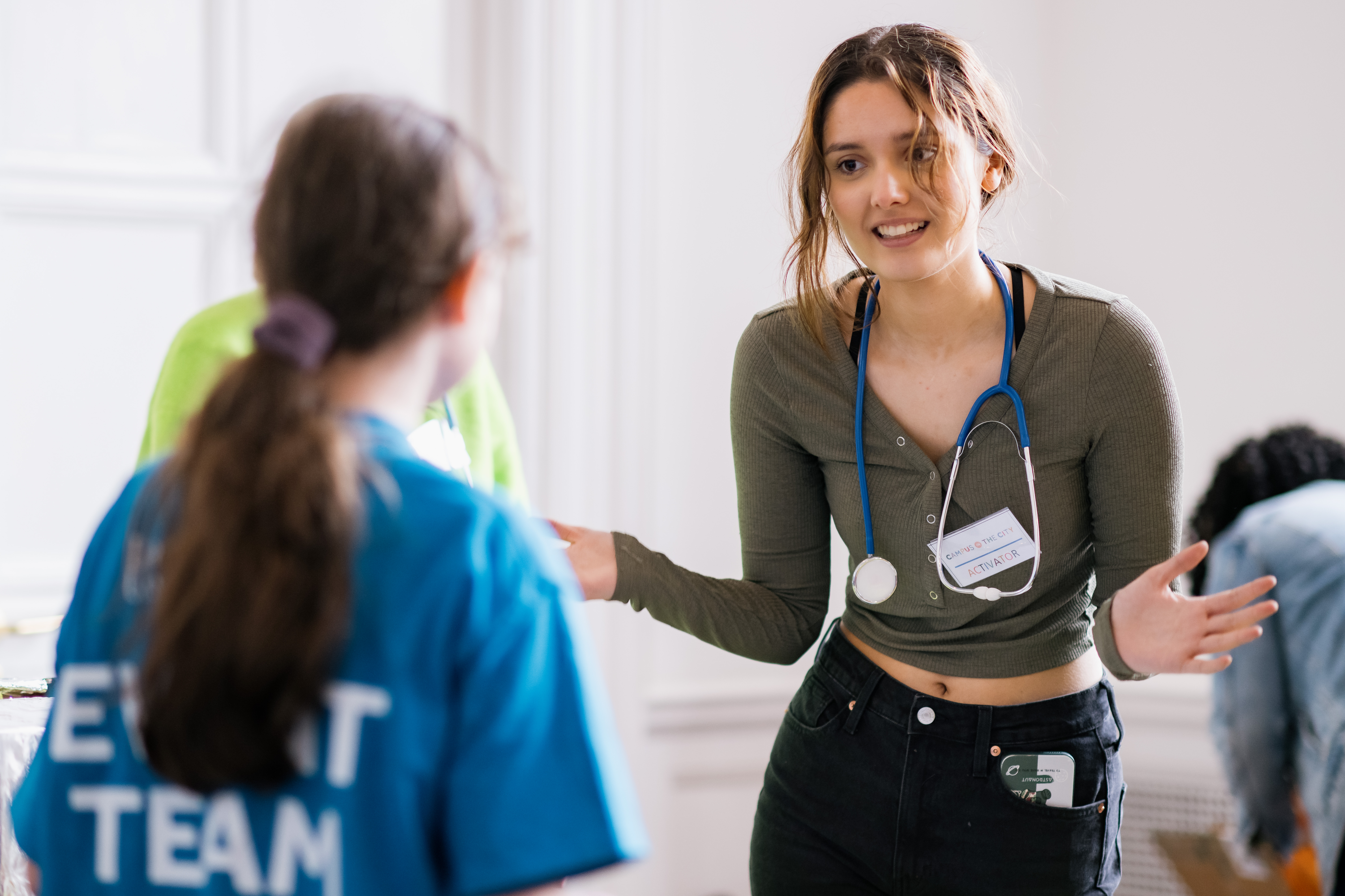 a doctor wearing a stethoscope talks to someone