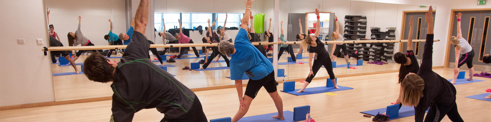 An instructor takes a yoga class in one of the studios