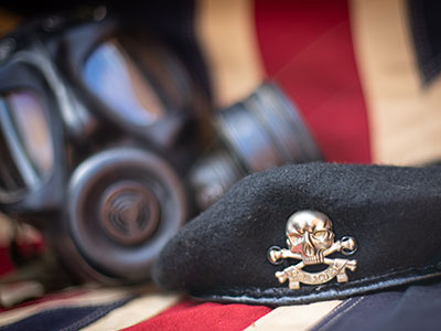 Gas mask and regimental beret placed upon the Union Flag.