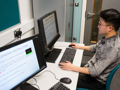 Student working on eye tracking sitting at a PC