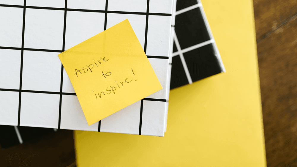 Post-it-note featuring the text 'Aspire to inspire!'