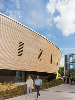 Students walking past buildings on campus