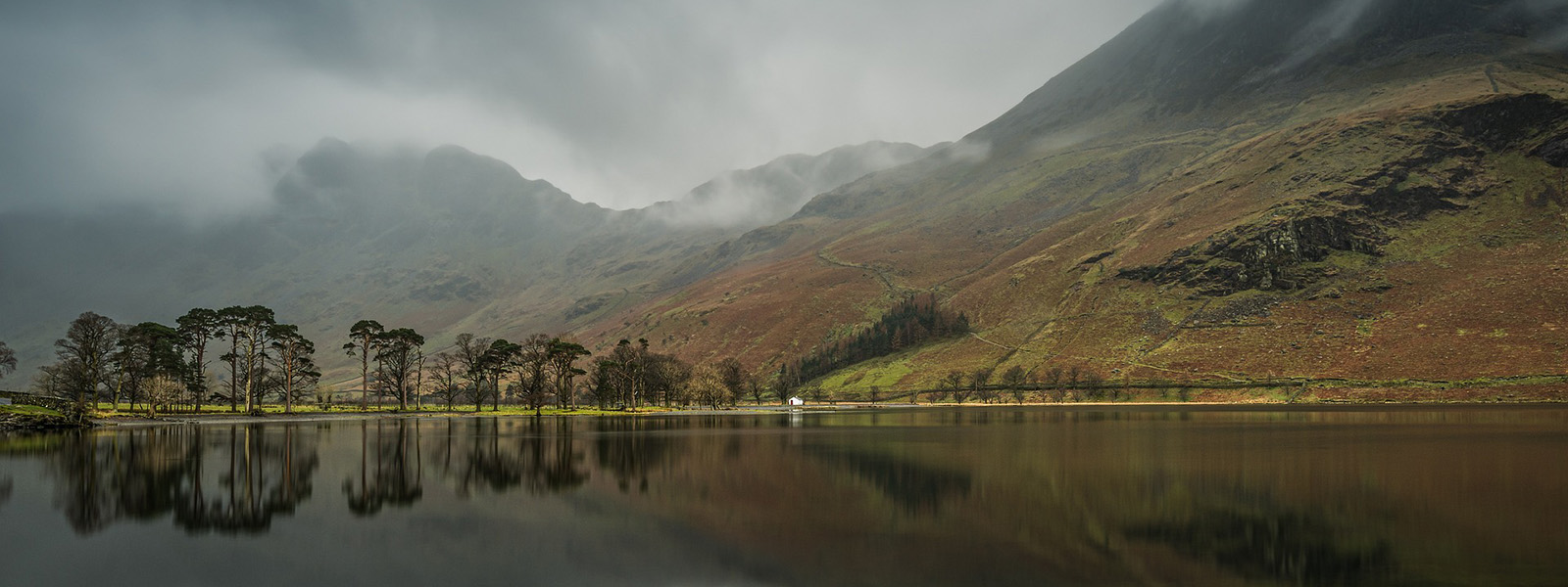 Lake Buttermere in Cumbria. A stormy sky mirrored in the still waters of the lake.