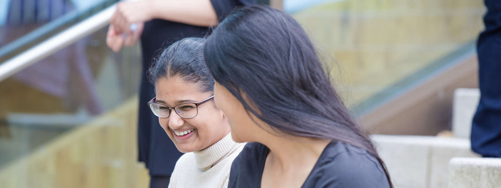 Two students laughing together