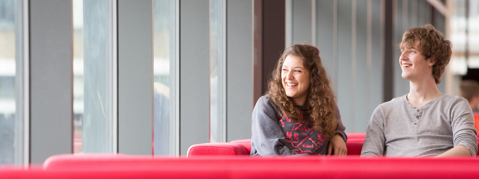 Two students are sat in the Learning zone on campus