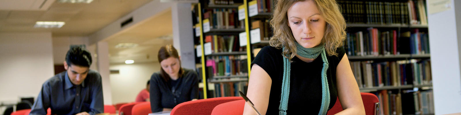 A student studies a text in the Lancaster University library.