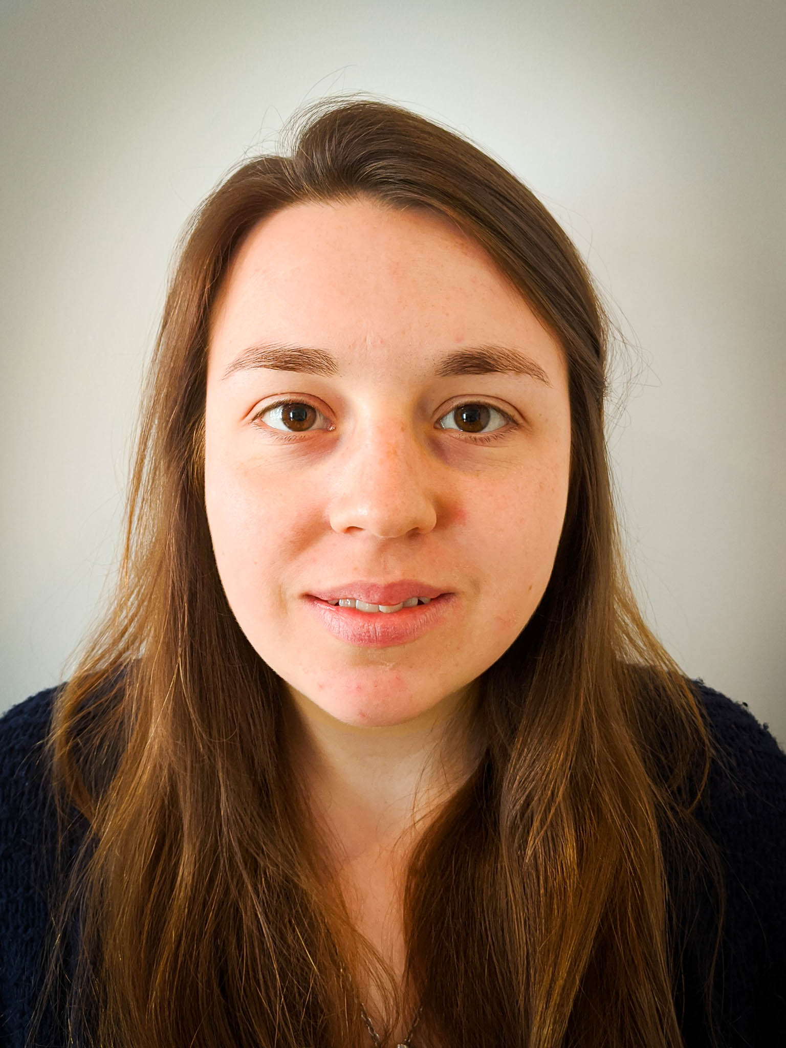 A young woman looking at the camera and smiling