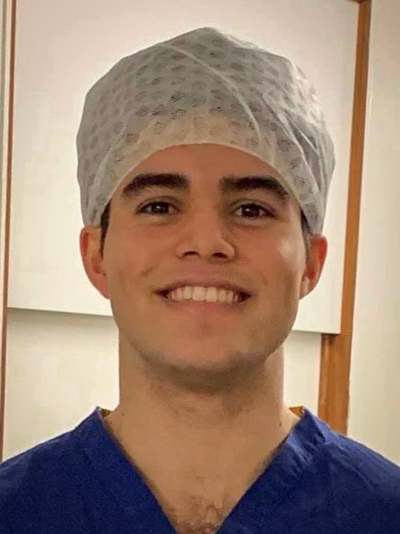 A young man wearing medical protective equipment