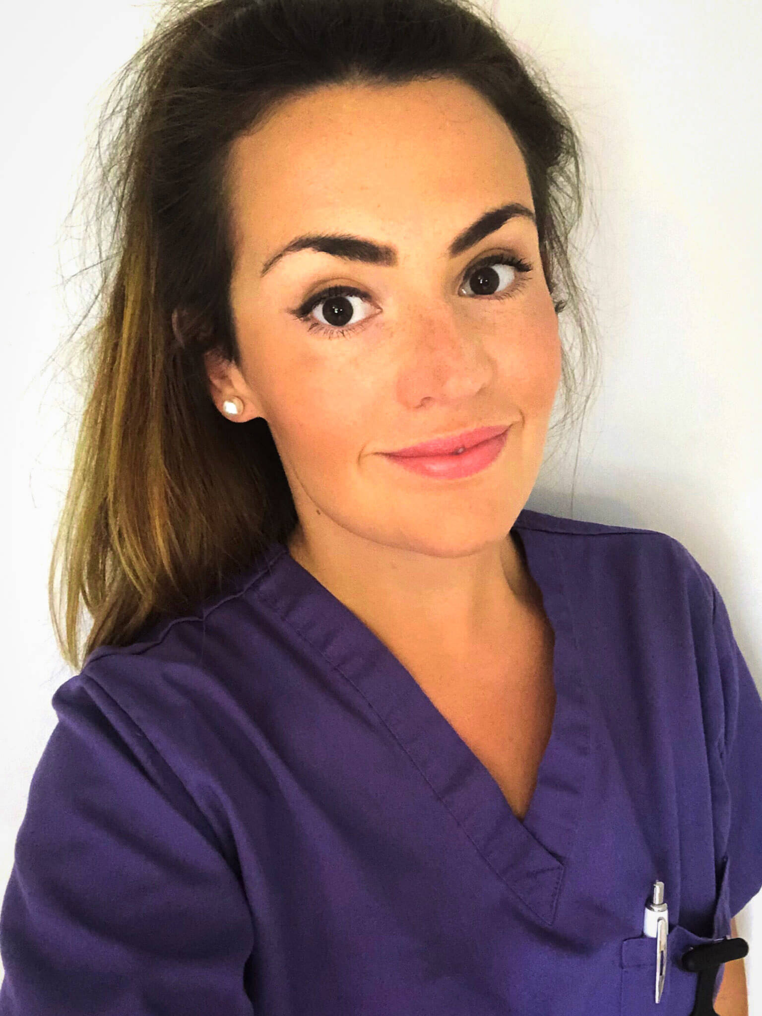 A woman wearing blue medical scrubs