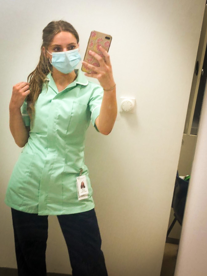 A health care assistant in PPE