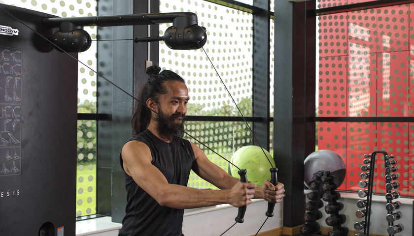 A person using a weight machine in the Sport at Lancaster facilities
