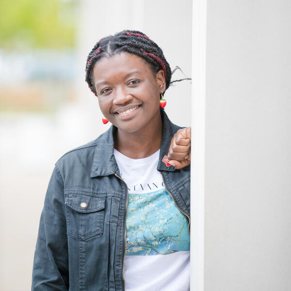 Student in a white t-shirt and denim jacket