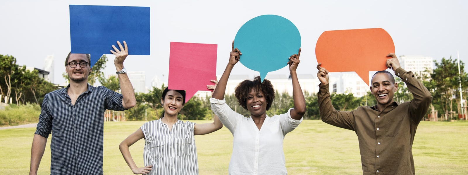 Four people holding empty speech bubbles