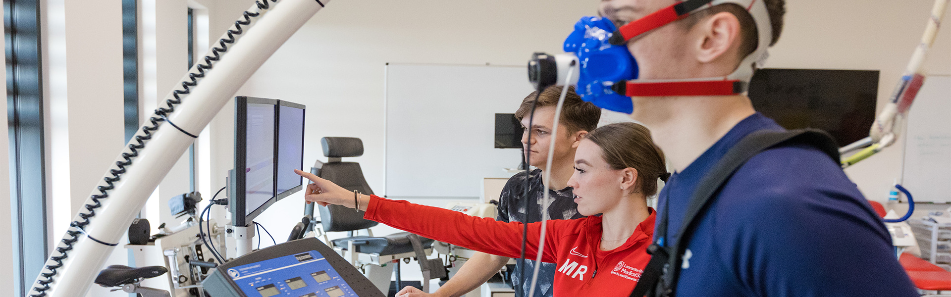 3 students are training. One is on a treadmill