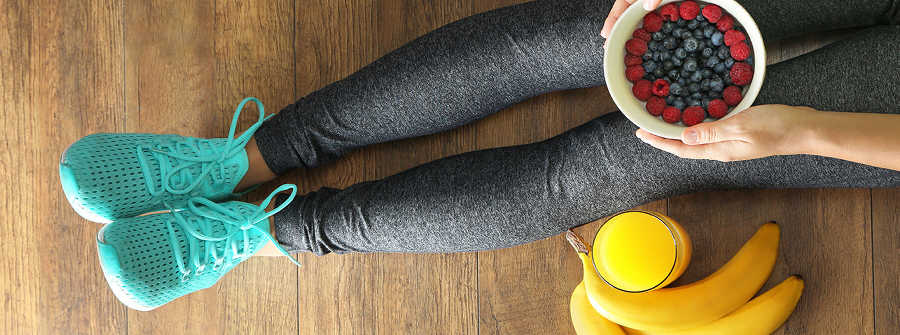 healthy living image of person in sports clothes with orange juice and blueberries