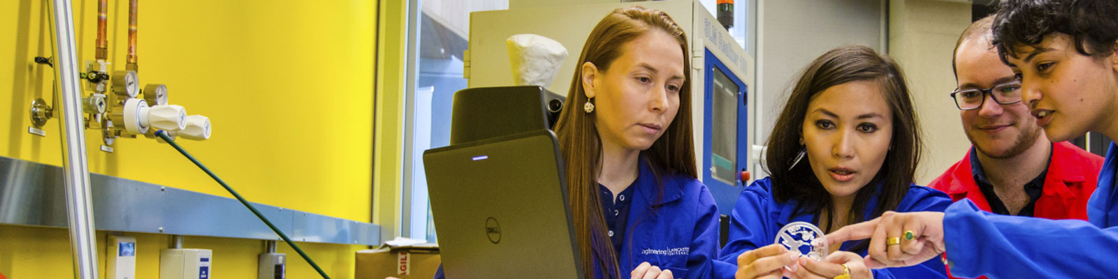 Staff and students inspect a 3D printed object