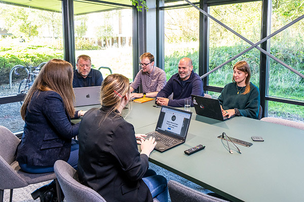 Several people sitting around a desk