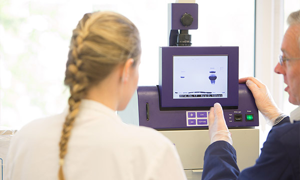 A student and staff member use the x-ray CT scanner