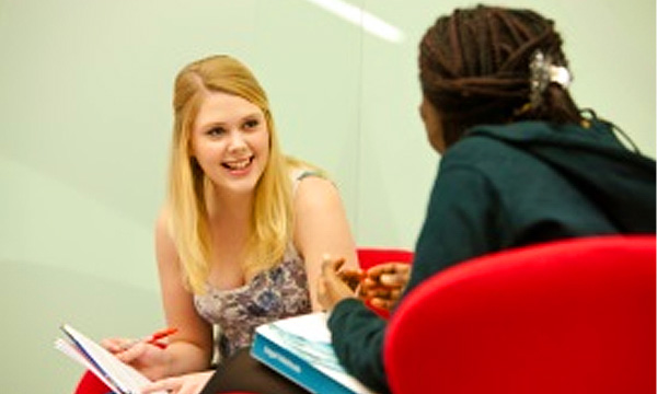 Two people talking in chairs