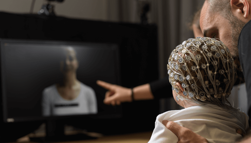 A baby wearing an EEG cap