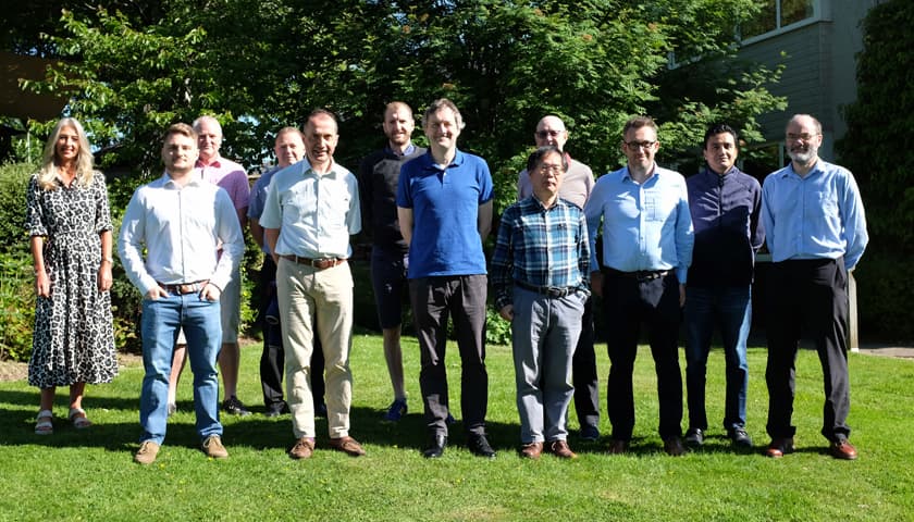 The AIRS team stood outside on a grassy field