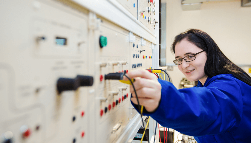 A student working on the electrical grid in the Engineering Projects Room