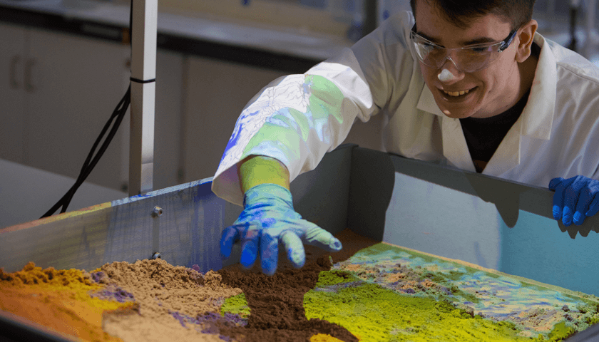 A student interacting with a projected model