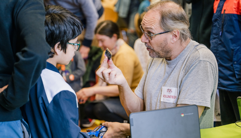 Joe showing a child a micro:bit