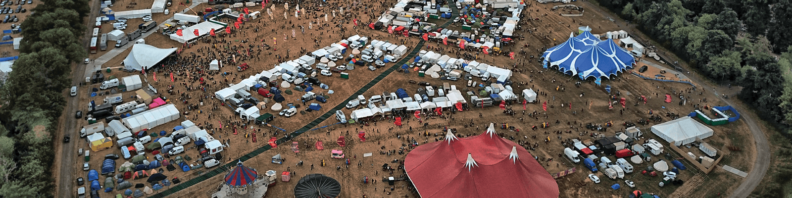 A large fair with marquees in a field