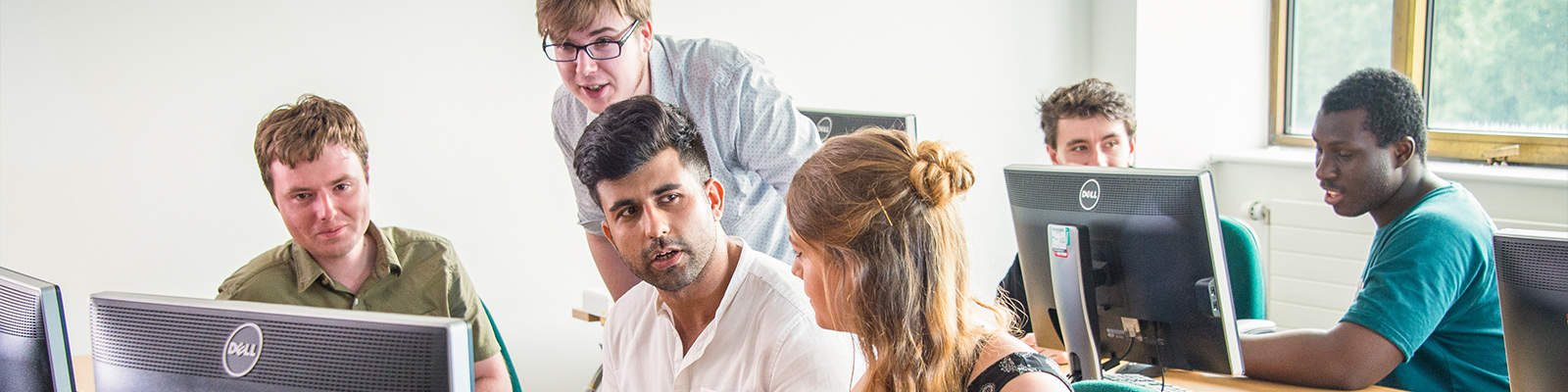 Postgraduate students sat in a computing lab